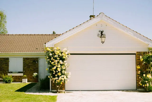 Short concrete driveway in front of a garage door