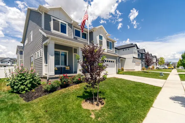 Concrete sidewalk and front walk along a row of houses